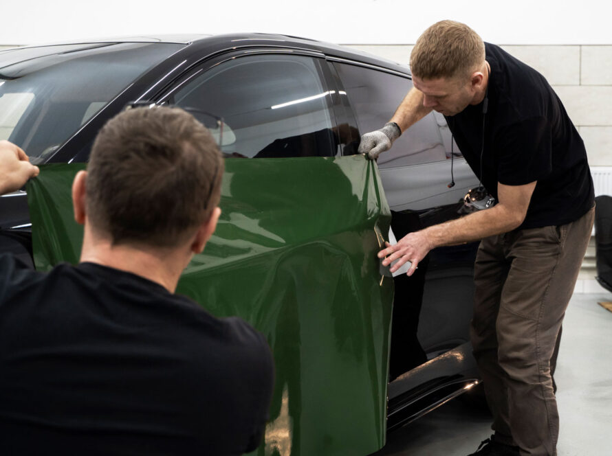 Specialist applying a sleek vinyl wrap to enhance the car’s look